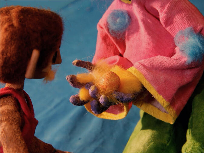 Alien holds a fruit